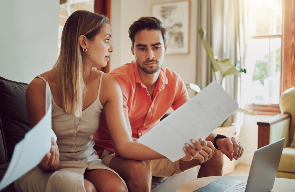 Young couple having a discussion over finance, savings and filing taxes when spouse owns a business.